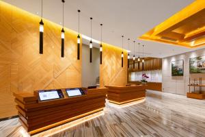 vestíbulo de un restaurante con paredes y luces de madera en Relins Grand Madison Hotel, en Guangzhou