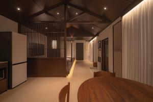a dining room with a table and chairs in a room at Generous Jeju in Jeju