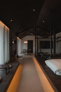 a bedroom with a bed and a dining room at Generous Jeju in Jeju