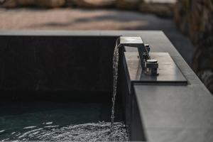 a fountain with water coming out of it at Generous Jeju in Jeju +24 photos