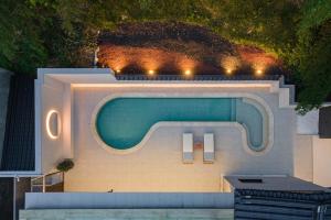 a swimming pool with two chairs and a swimming pool at Hoshiga Pool Villa in Yeongcheon
