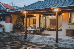 a house with a christmas tree on a patio at Gurye Taepyeonghan Daepyeong in Gurye