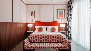 a bedroom with a large bed with a red headboard at Sugar Marina Hotel -POP- Kata Beach in Kata Beach