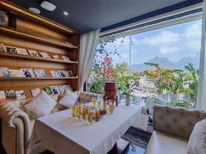 a dining room with a table and a large window at Sean Castle Resort Inn -Zhangjiajie Tianmenshan Cableway Branch-Free hotel to Tianmenshan cableway entrance service in Zhangjiajie