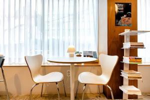 a table and chairs in a room with a window at Jeju Goyo Walk in Jeju