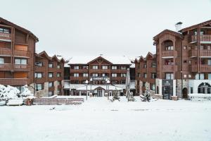 a snow covered courtyard in front of a building at Fahrenheit Seven Courchevel in Courchevel