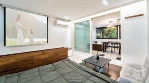 a bedroom with a large painting on the wall at Gapyeong Pop Pension in P'yŏngban-ni