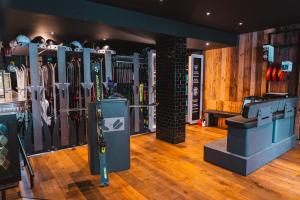 a room with a bunch of skis on a wall at Fahrenheit Seven Courchevel in Courchevel +69 photos
