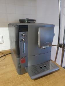a coffee maker sitting on top of a table at Ferienwohnung Tammer Allee in Tamm +6 photos