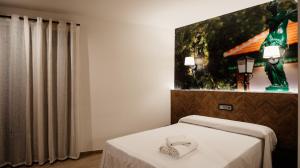 Postel nebo postele na pokoji v ubytování Hostal Central Marmolejo