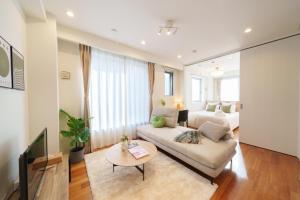 a living room with a couch and a bed at Space Roppongi in Tokyo