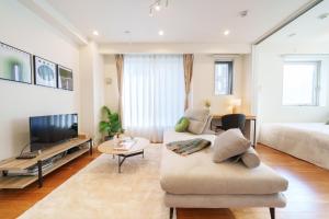 a living room with a couch and a tv at Space Roppongi in Tokyo +31 photos