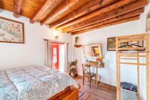 a bedroom with a bed and a wooden ceiling at Tis Manas in Asklipiḯon