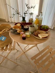 a table with a breakfast of bread and toast at Blue Door Mallorca in Caʼs Concos