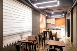 a room with tables and chairs and a kitchen at Chason M Dongdaemun in Seoul