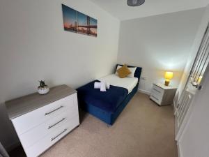 a small bedroom with a bed and a dresser at Kingsway House - Spacious 4 Bed Home From Home in Derby in Derby