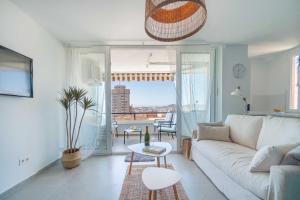 a living room with a white couch and a table at One bedroom apartment next to the port in Fuengirola