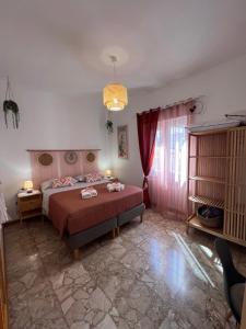 奇维塔韦基亚Casa Dharma Guest House的卧室里有一张床，床罩是红色的