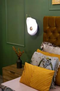 a bedroom with a bed with a lamp and a table at Χρυσηίδα - Chrysiida Luxury Apartment in Nafplio