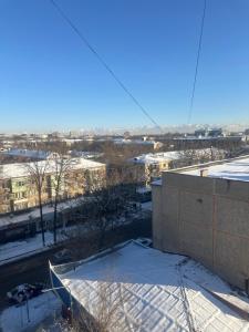 a view from the roof of a building in the snow at 1 комнатная квартира Lux класса в центре Шымкента in Shymkent