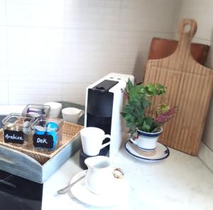 a counter with cups and a coffee maker on it at La casetta in Candelo +6 photos