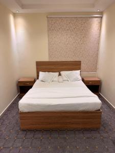 Ένα ή περισσότερα κρεβάτια σε δωμάτιο στο لاقينا هوم- شقق مخدومة شظاه