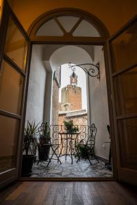 an open door to a patio with a table and a castle at Residenza Monaldeschi in Orvieto