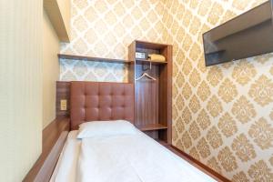 Postel nebo postele na pokoji v ubytování Hotel Urania