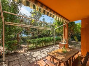 a patio with a table and chairs on a patio at Pinus Blissful Breeze in Pula