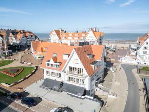 an aerial view of a town with the ocean at Stunning 3-Bedroom apartment with panoramic view in De Haan