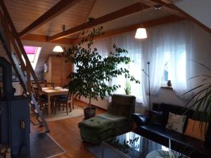 a living room with a couch and a chair and a table at Ferienwohnungen Leffer in Großheirath