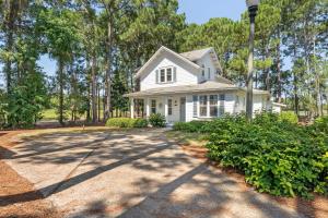 a white house with trees in the background at 1369 Laurel Grove "The Crows Nest" in Destin