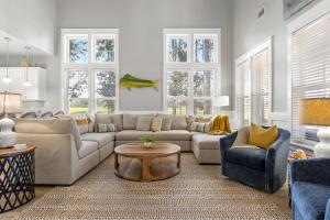 a living room with a couch and a table and chairs at 1369 Laurel Grove "The Crows Nest" in Destin