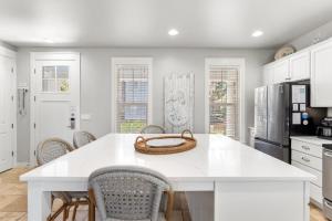 a kitchen with a white island with a basket on it at 1369 Laurel Grove "The Crows Nest" in Destin