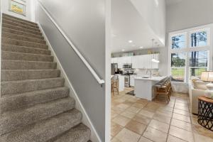 a staircase leading to a kitchen and a living room at 1369 Laurel Grove "The Crows Nest" in Destin