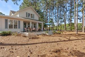 a house with a porch with two chairs at 1369 Laurel Grove "The Crows Nest" in Destin