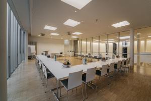 a large conference room with a long table and chairs at Gästehaus Auf dem Heiligen Berg B&B in Wuppertal