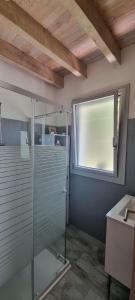 a glass shower in a bathroom with a window at La Petite Maison-Les logis d'Agaliaure in Château-Verdun +27 photos