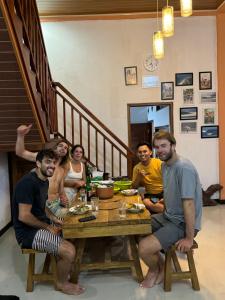 a group of people sitting around a table at Walur Surf Villa in Krui