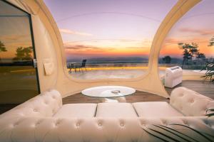a living room with a couch and a table at Glamping Balú in Monesterio
