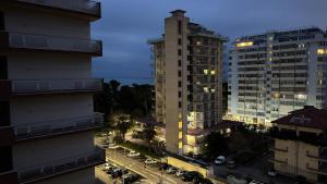 a view of a city at night with buildings at 085 luxury apartment in Montesilvano