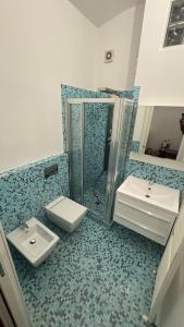 a bathroom with two sinks and a shower and a toilet at 085 luxury apartment in Montesilvano +32 photos