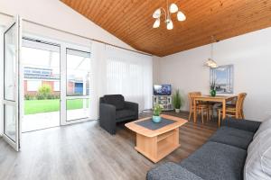 a living room with a couch and a table at Ferienhaus Julia in Bensersiel