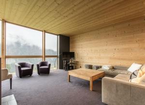 a living room with a couch and a table at Chalet du Saix in Châtel