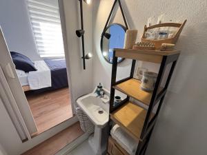 a small bathroom with a sink and a mirror at Grupo Gontad Apartamento Mourelle Corme in Corme-Puerto