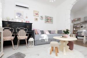 a living room with a bed and chairs and a table at House Ingrid in Rijeka