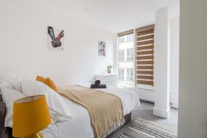 a white bedroom with a bed and a window at Host & Stay - Maple Court in Ipswich +12 photos