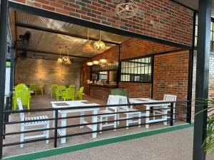 a patio with a table and chairs and a brick wall at The Stage-Koh Chang in Ko Chang