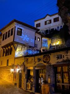 a building with a sign on top of it at night at Villa Aurelia Old Town in Kavala