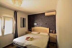 a bedroom with a large bed and a window at Elisabet in Denia +18 photos